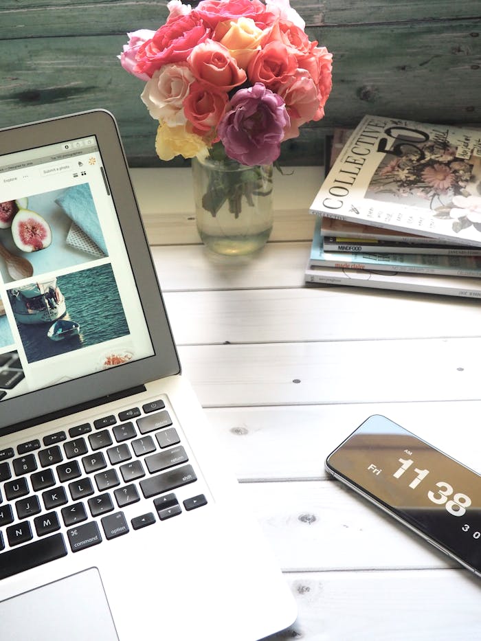 gallery-01 Elegant workspace featuring a laptop, smartphone, and fresh roses in a bright setting.